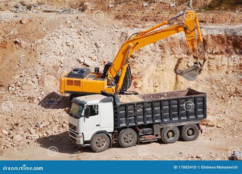 loading trucks with excavator